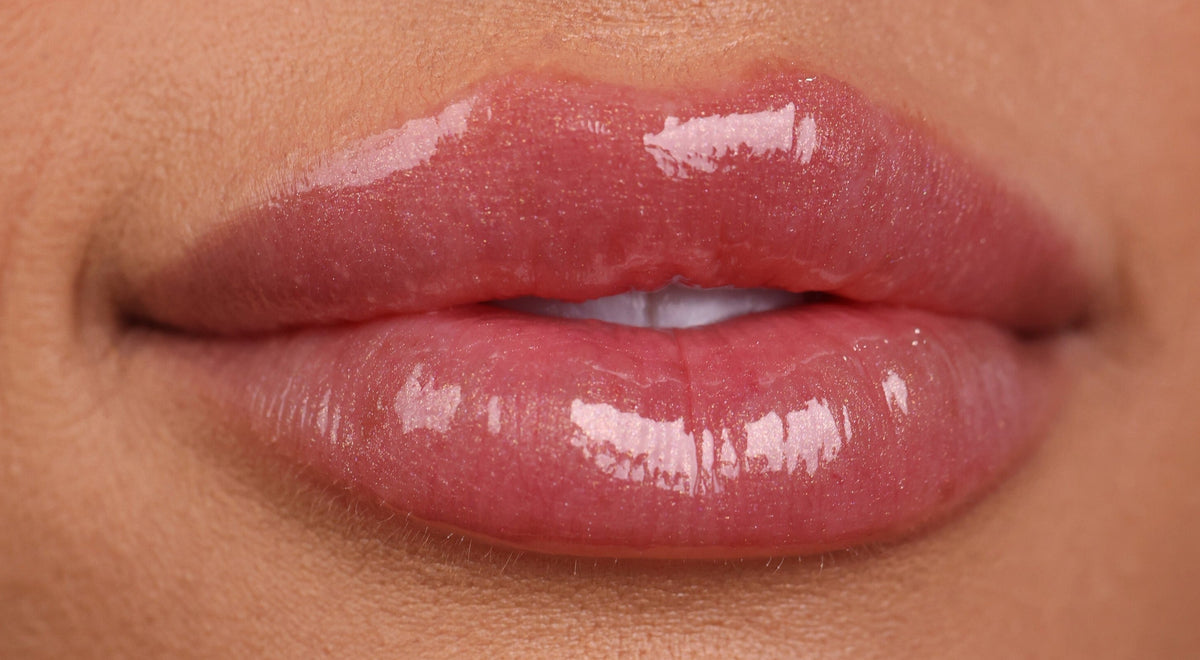 Close-up of a person's lips with a glossy lip color.